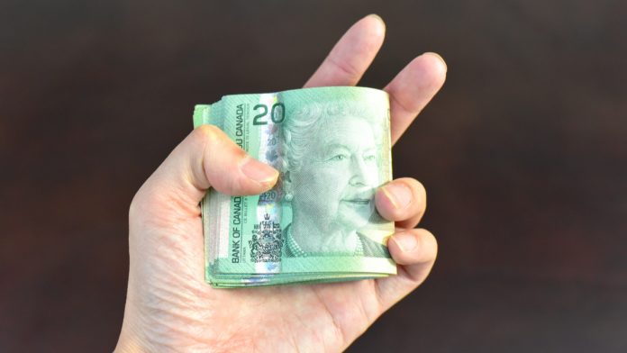 canadian-dollars-in-hand